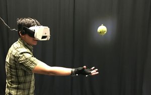 Catching a Real Ball in Virtual Reality